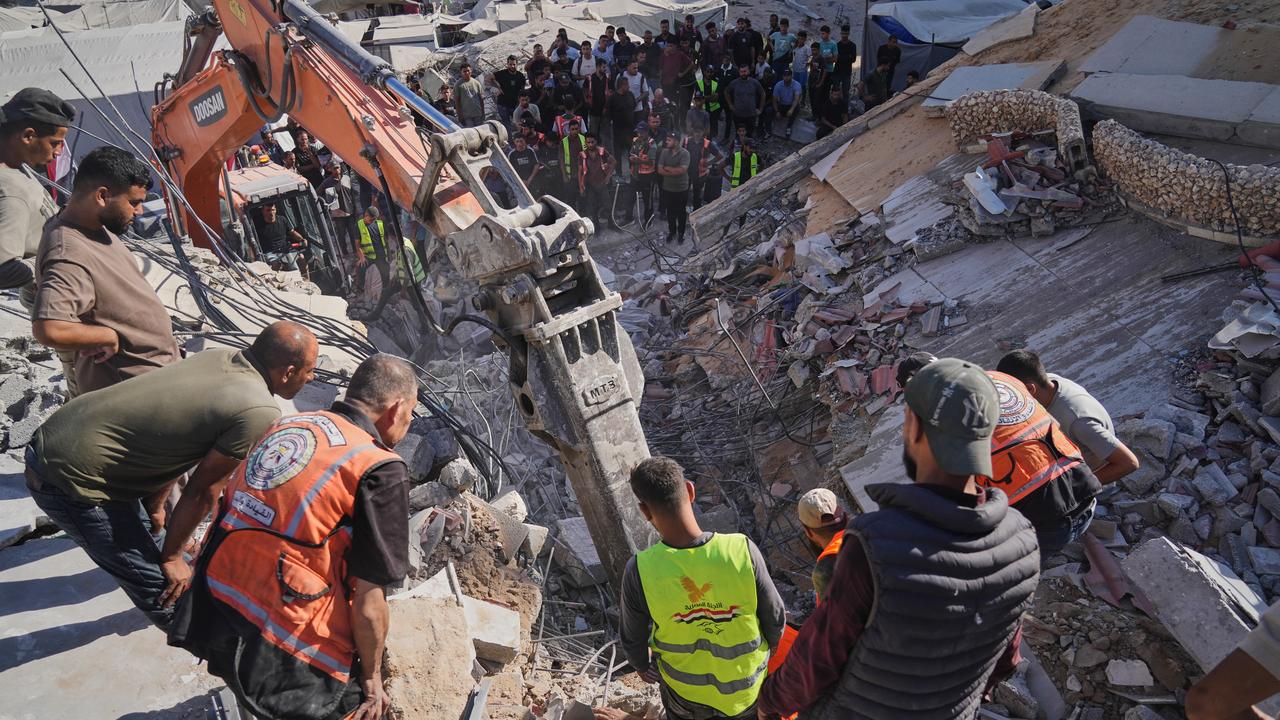 Crews search for bodies in the rubble of a collapsed building in Gaza