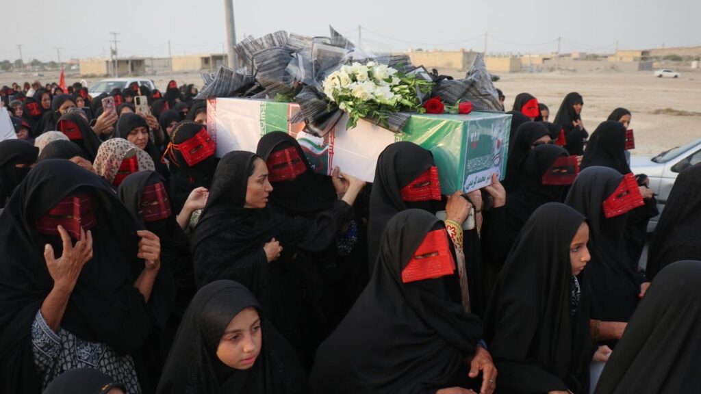 Mourners have carried caskets wrapped in the Iranian flag in the streets of port town Kuhestak.
