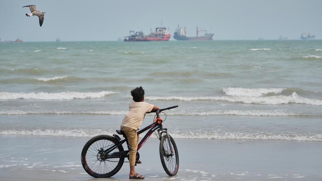 A beach in Iran overlooking vessels anchored in the Strait of Hormuz