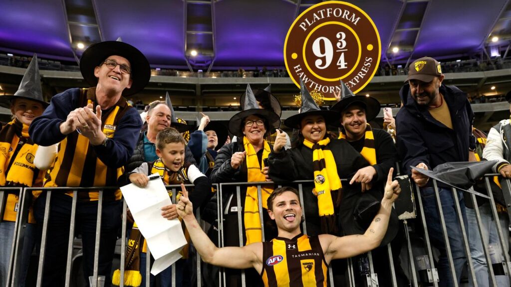 Nick Watson with his fans wearing witches hats after Hawthorn’s qualifying-final win over Fremantle.
