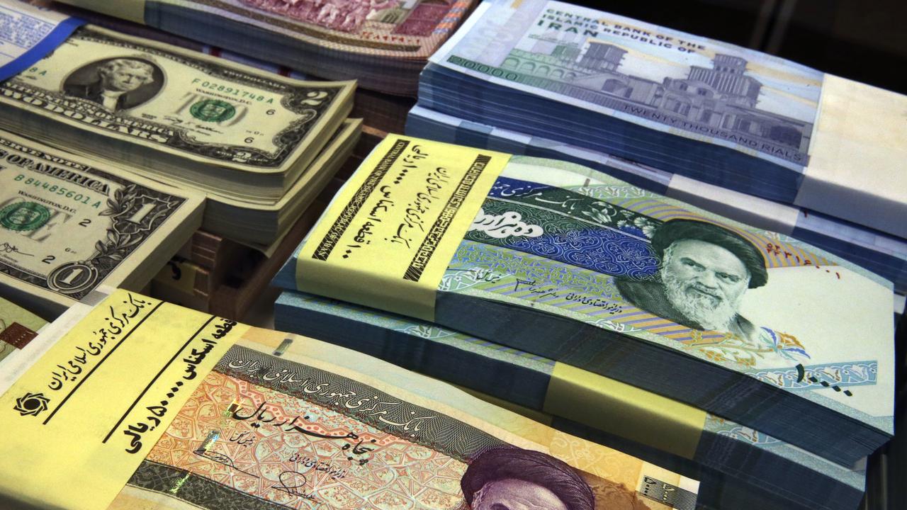 Iranian and US banknotes are on display at a currency exchange shop