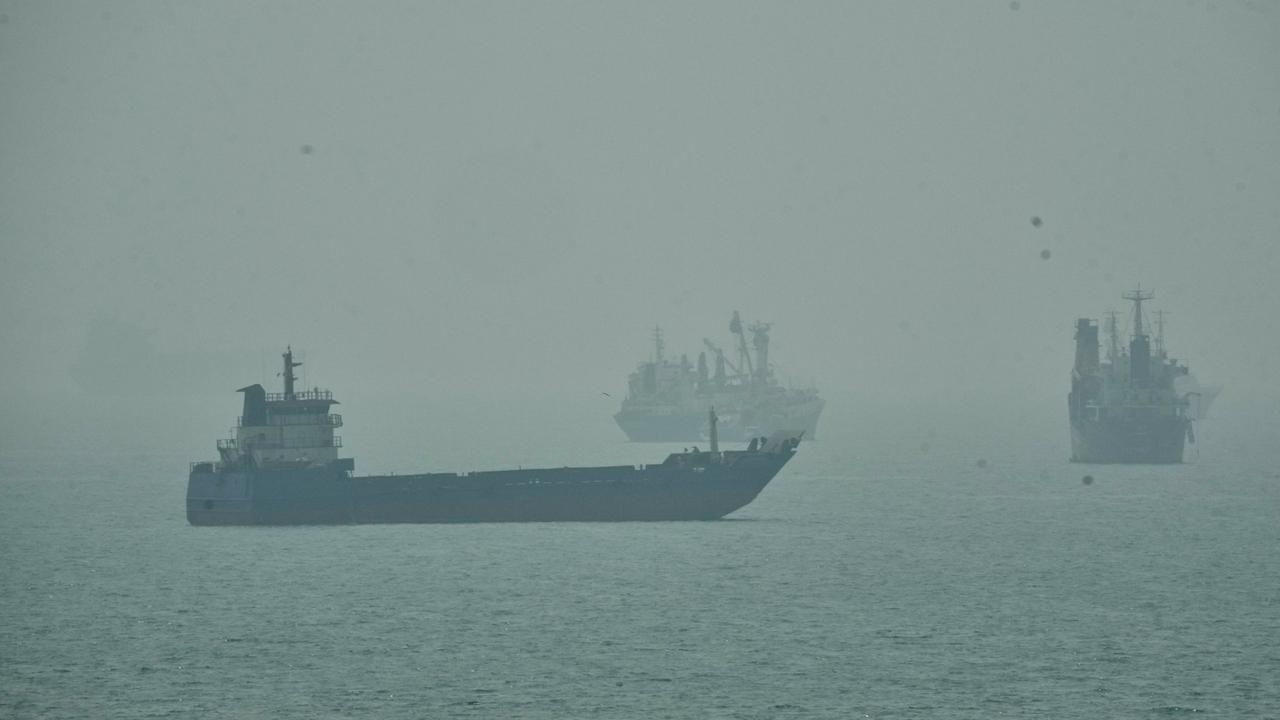 Commercial vessels anchored amid haze in the Strait of Hormuz
