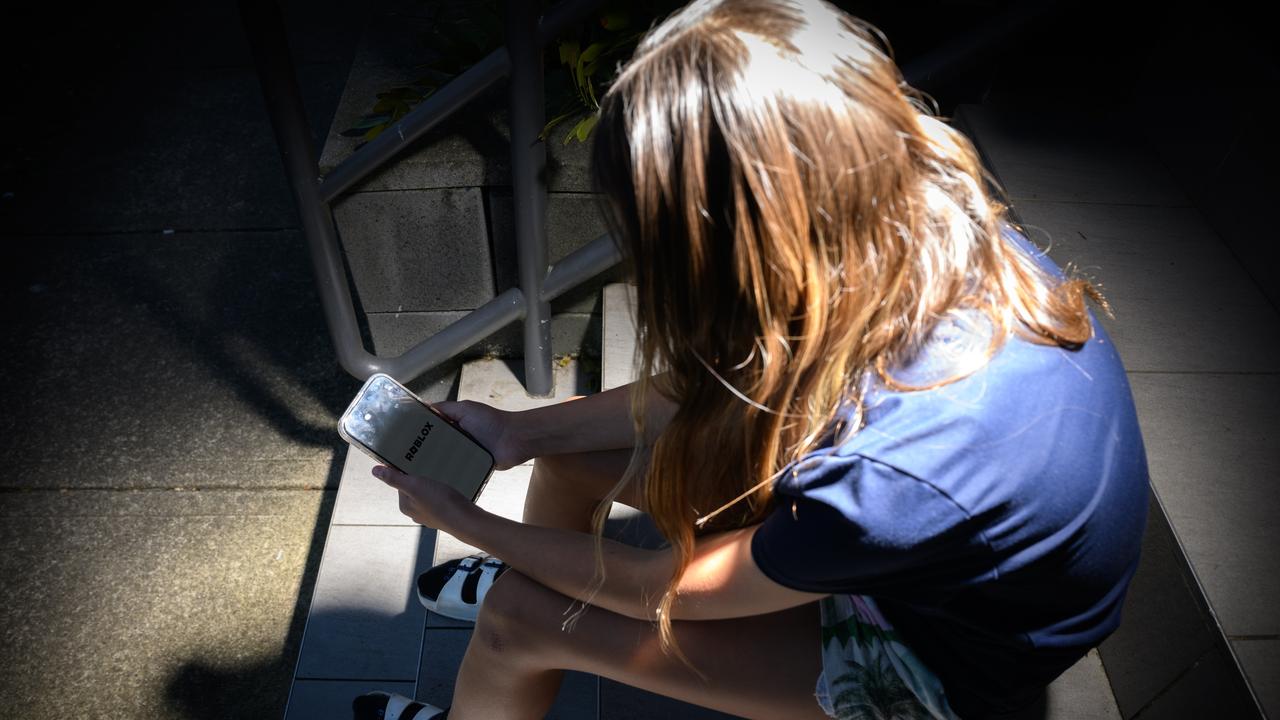 A young person on their phone