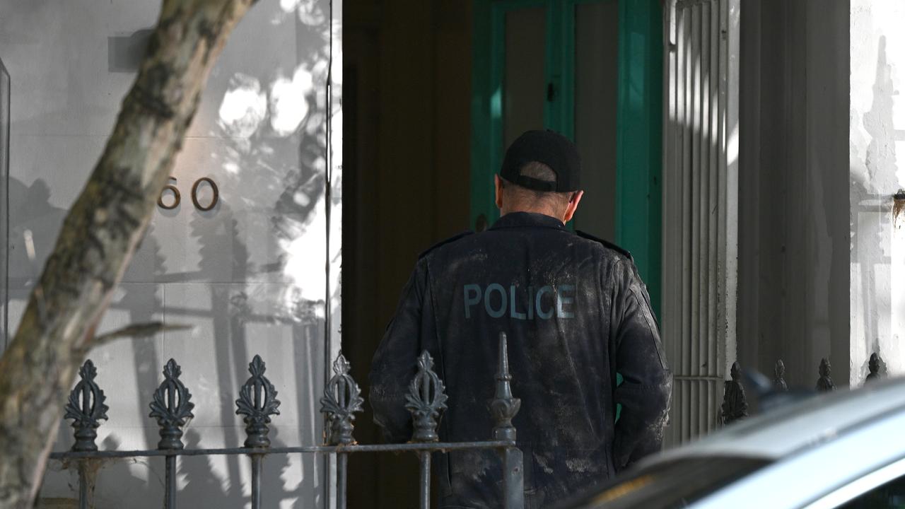 police officer at front door of townhouse