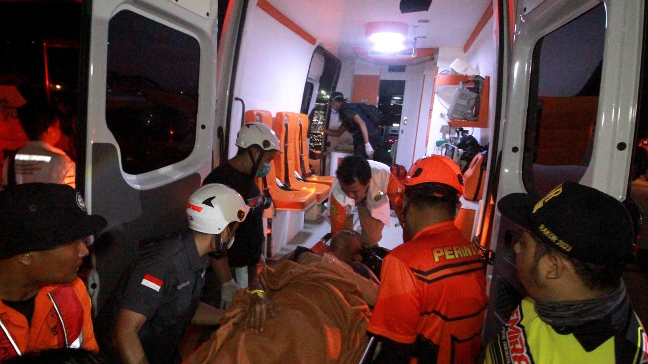 An injured survivor of a ferry accident onto an ambulance