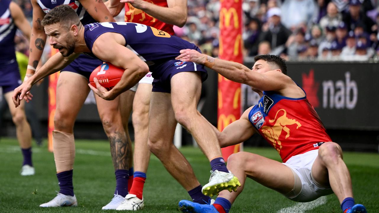 Sam Switkowski of the Dockers is tackled by Dayne Zorko