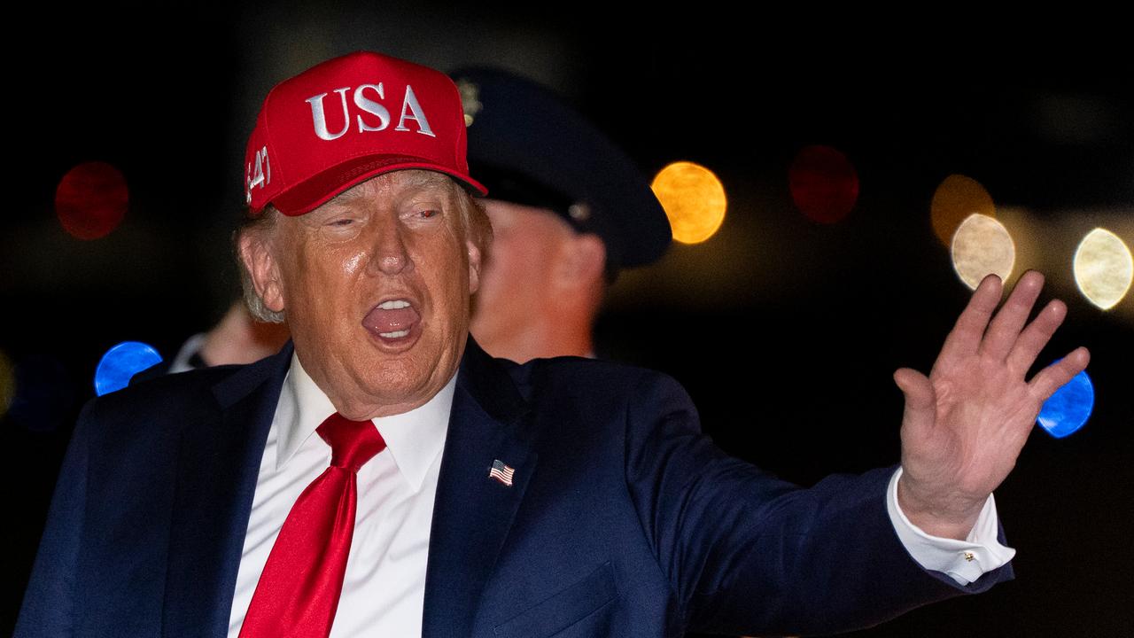 US President Donald Trump waves as he arrives on Air Force One