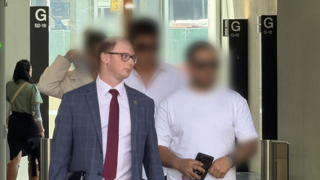 The parents and lawyer of a 15-year-old boy accused of murder leave a court on Thursday.

