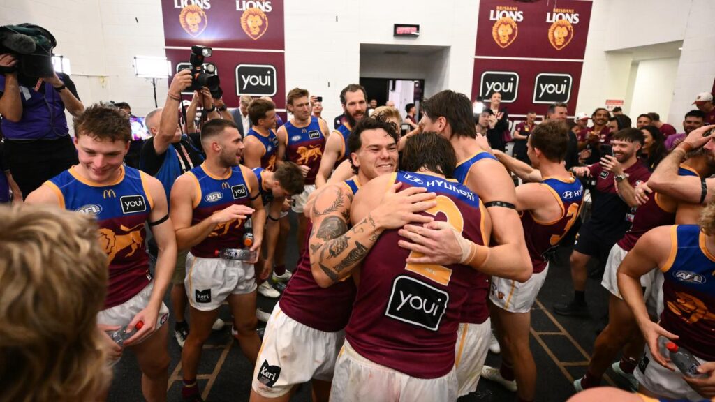Brisbane players celebrating their triumph in one of the great AFL matches at the MCG.
