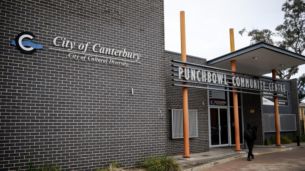 A boxing coach was shot multiple times in an ambush outside a community centre.
