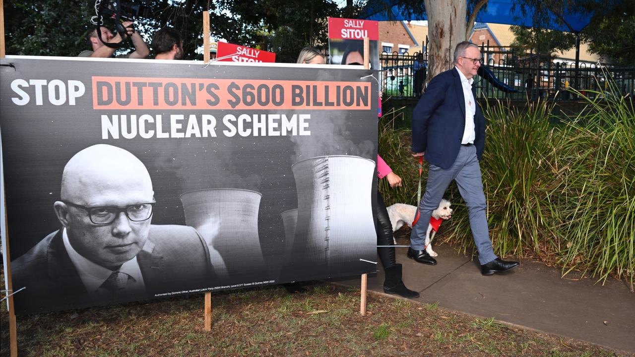 Anthony Albanese walks past a political advertising board (file image)