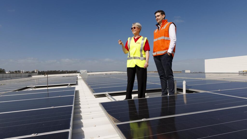 Coles’ Jane Mansfield and Origin’s Liam McWhirter inspect solar panels on top of the supermarket.

