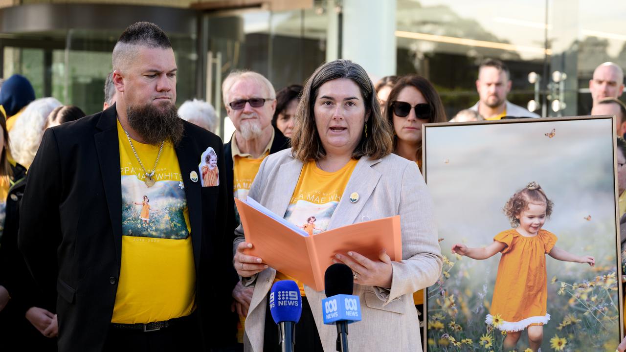 Annah White speaks next to photo of daughter