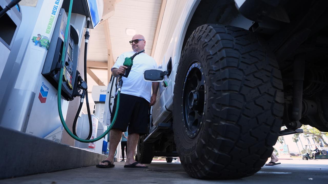 A man puts $US175 dollars of diesel in his truck in California