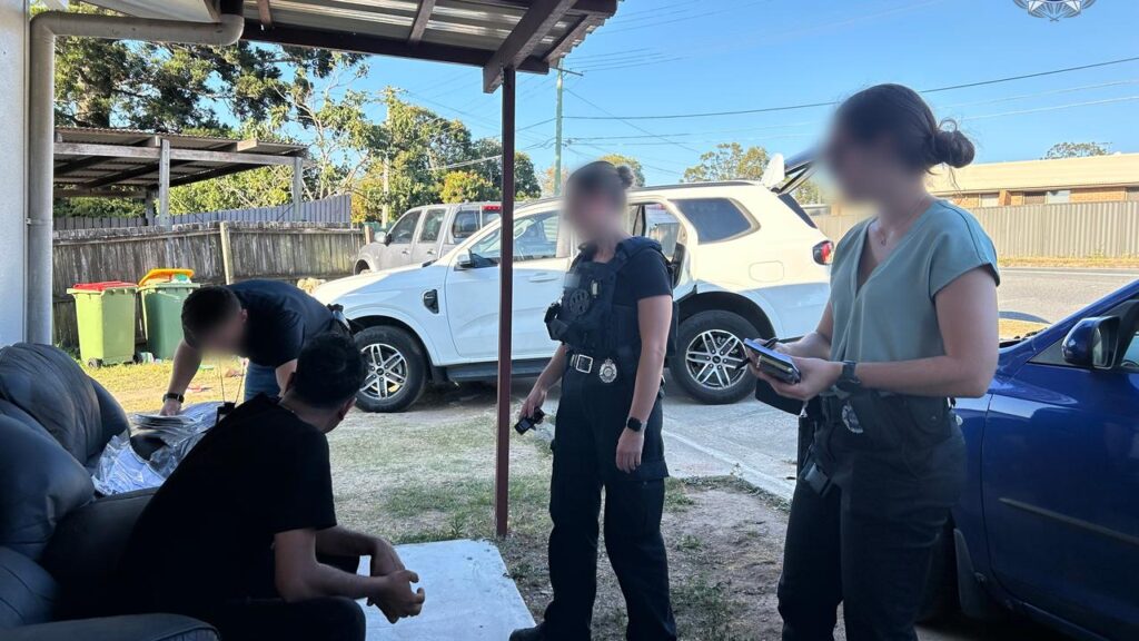 A man whose wife died overseas has been charged with bribing officials to influence their probe.
