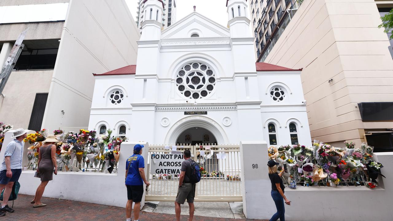 White synagogue with six-foot-high gate