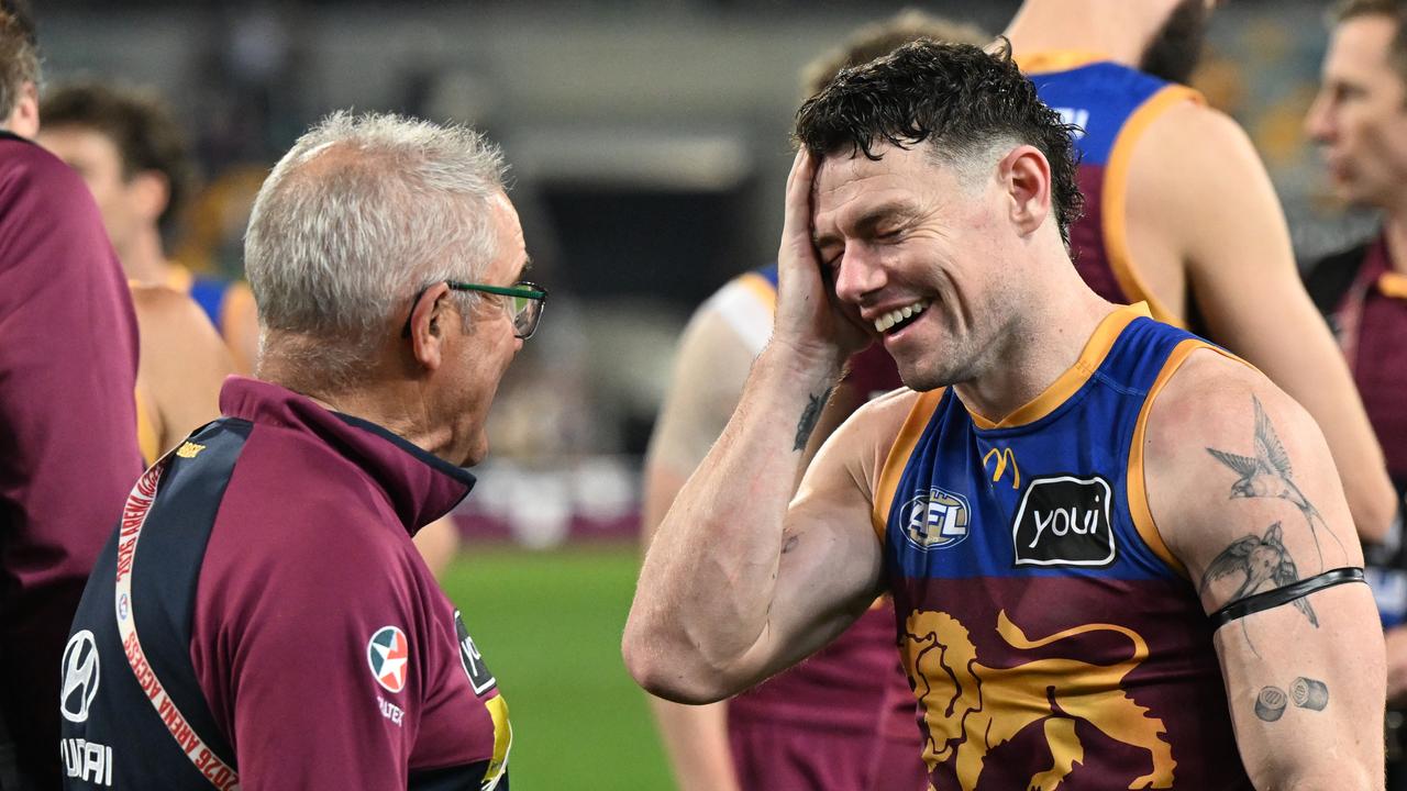Lions coach Chris Fagan and Lachie Neale