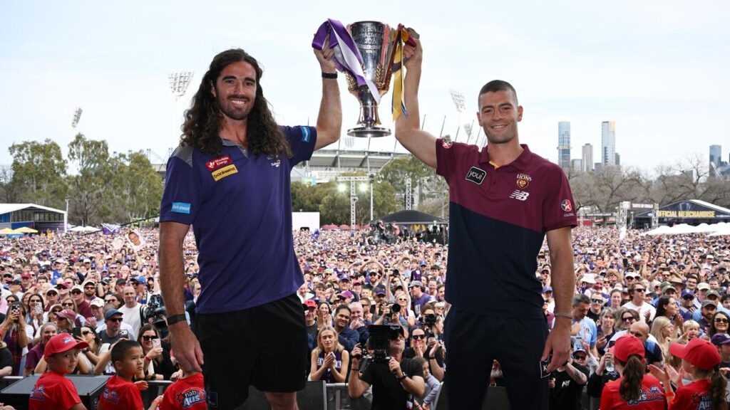 Chasing history: Dockers skipper Alex Pearce and Lions co-captain Josh Dunkley hold the big prize.
