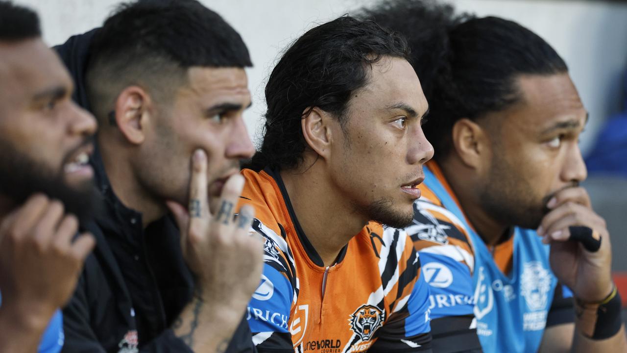 Jarome Luai of the Tigers sits on the bench