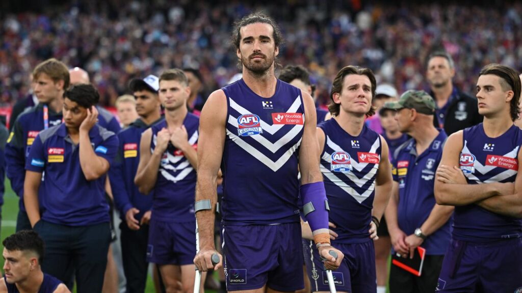 “Everyone’s devastated”: Alex Pearce put on a brave face after injury ended his grand final early.
