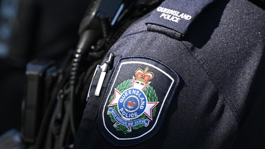 A Queensland Police officer has chased down an offender despite being stabbed in the neck.
