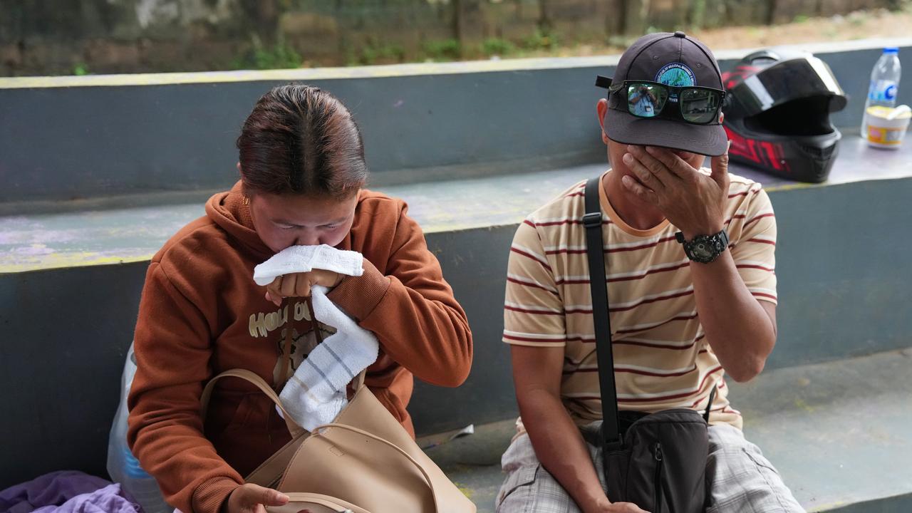 Lira Daco (l) and husband Menandro await news of  missing daughter.