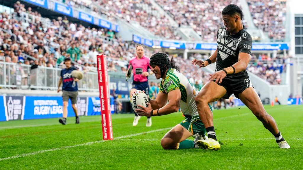 Esom Ioka (left) scores one of his three tries for Cook Islands against New Zealand.
