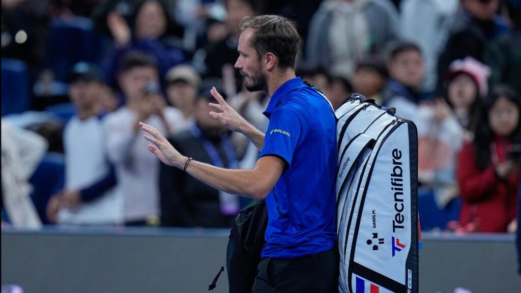 Daniil Medvedev leaves the court in Beijing after being disqualified against Novak Djokovic.
