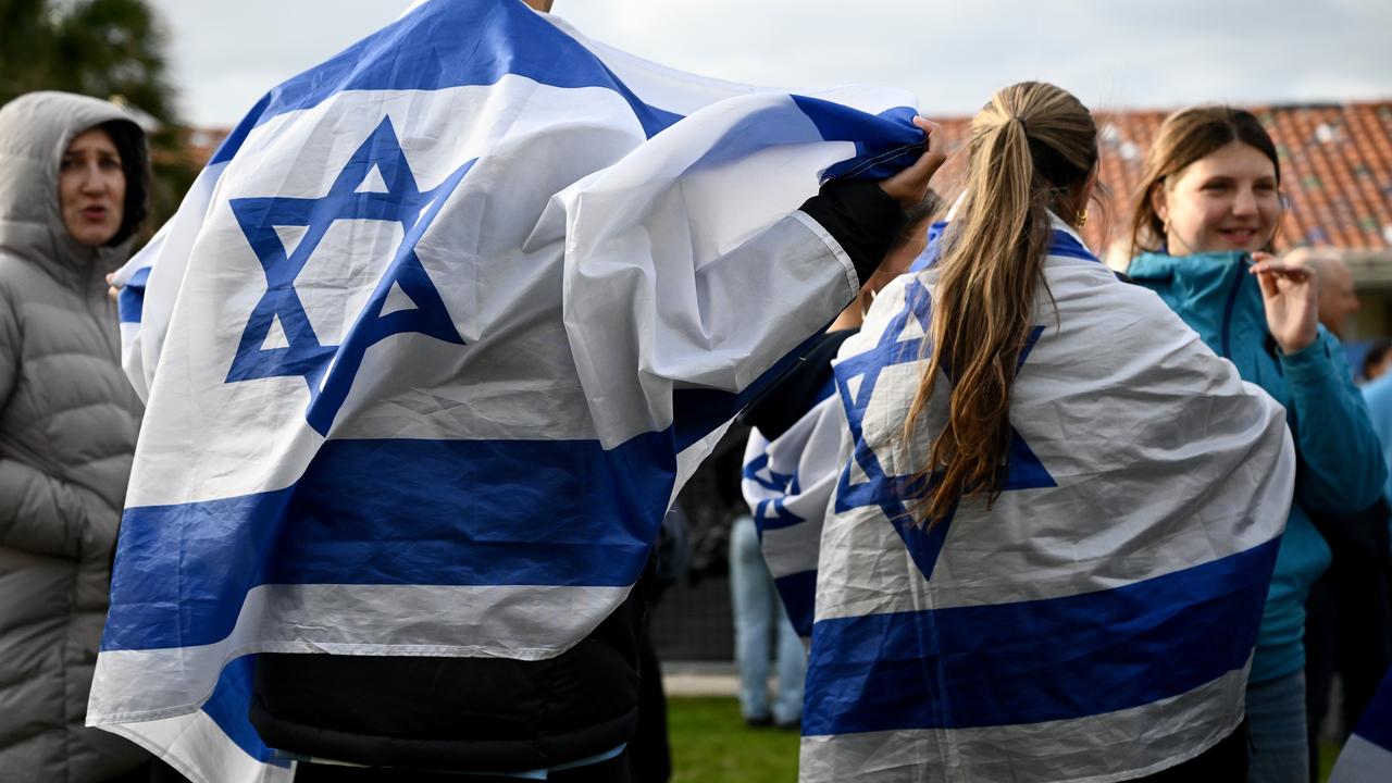 People with Israeli flags, marking the October 7 anniversary