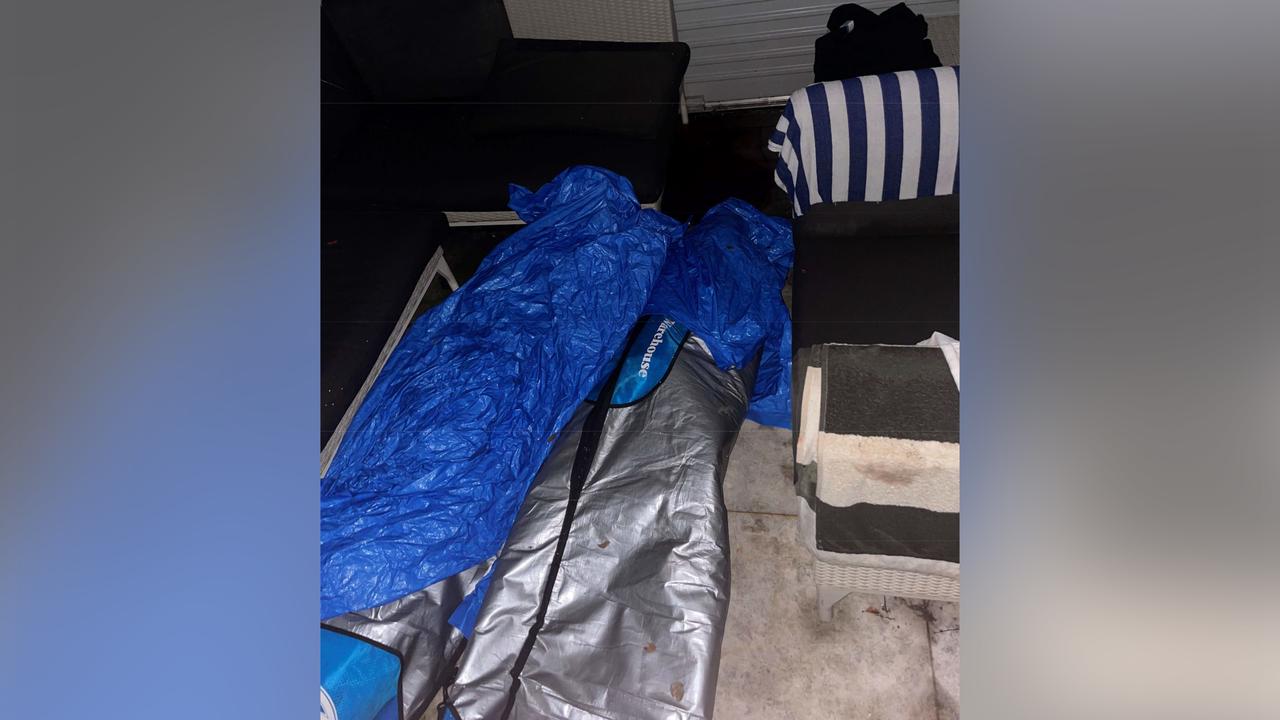 surfboard bags covered with blue tarp