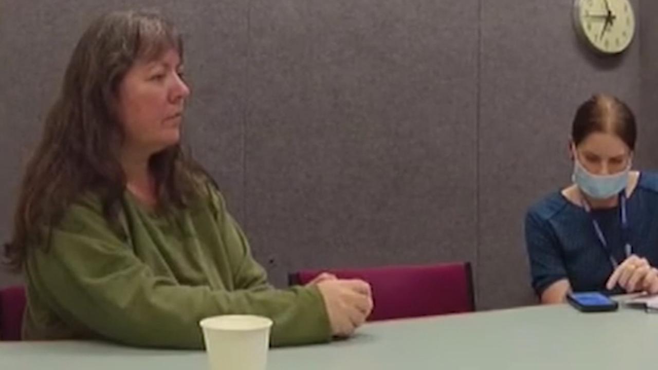 woman speaks with police