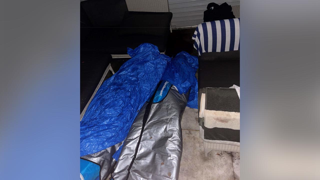 surfboard bags and tarps over them