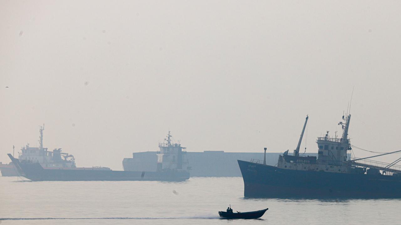 commercial vessels appear anchored in the Strait of Hormuz