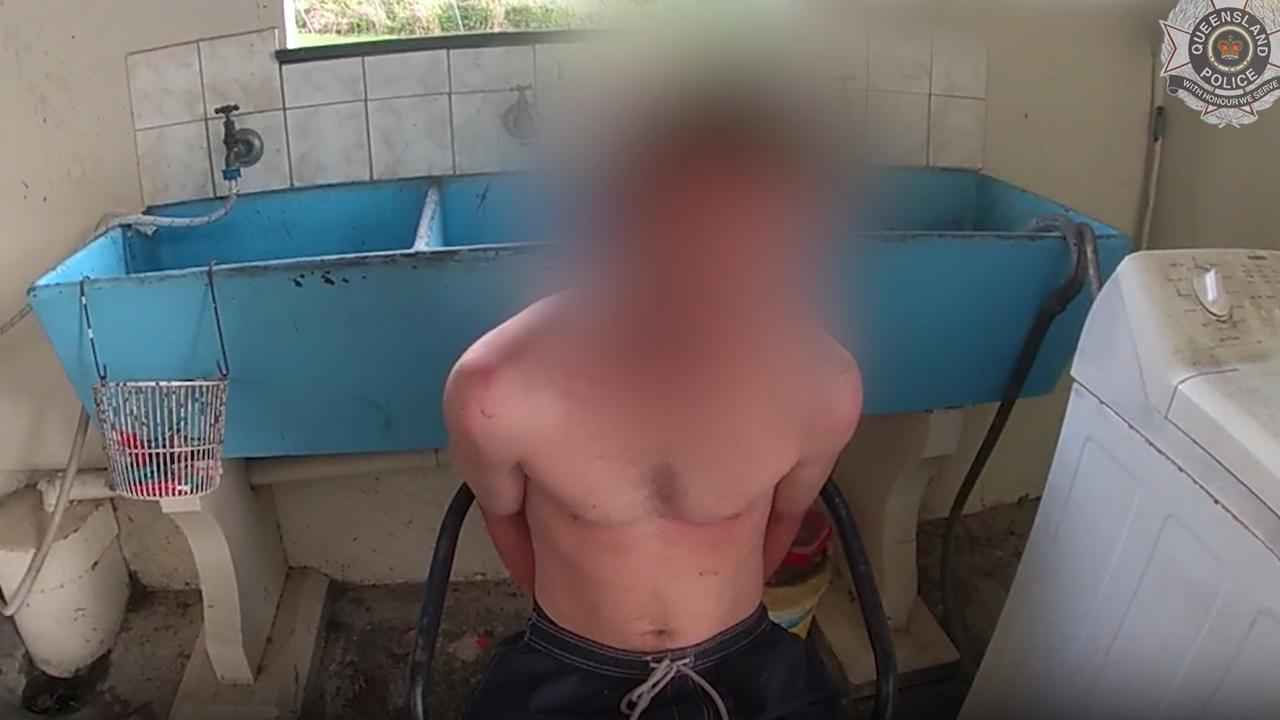 Queensland police arrest a man during the search of a property