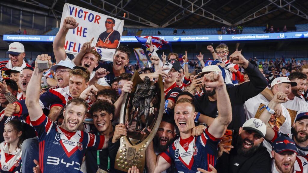Sam Walker (L) celebrates the Roosters’ NRL grand final triumph along with Daly Cherry-Evans.
