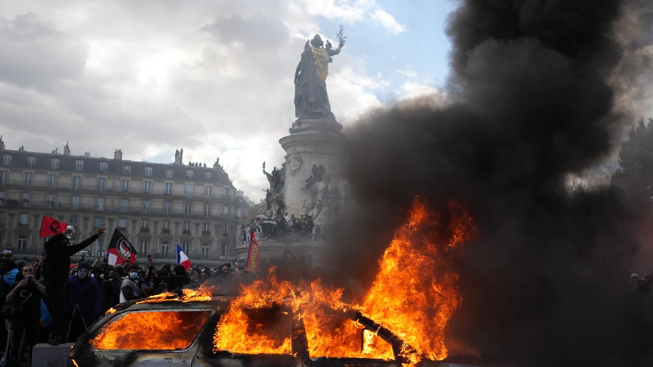 A car burns at Republique square in Paris