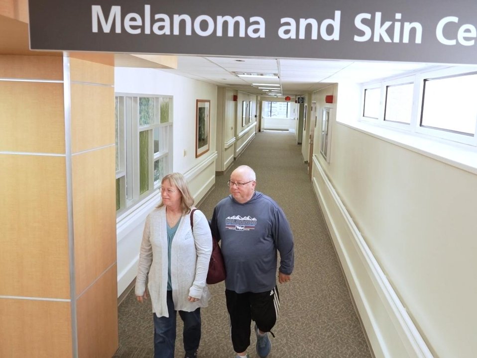 A couple walk through the halls of a US cancer centre.