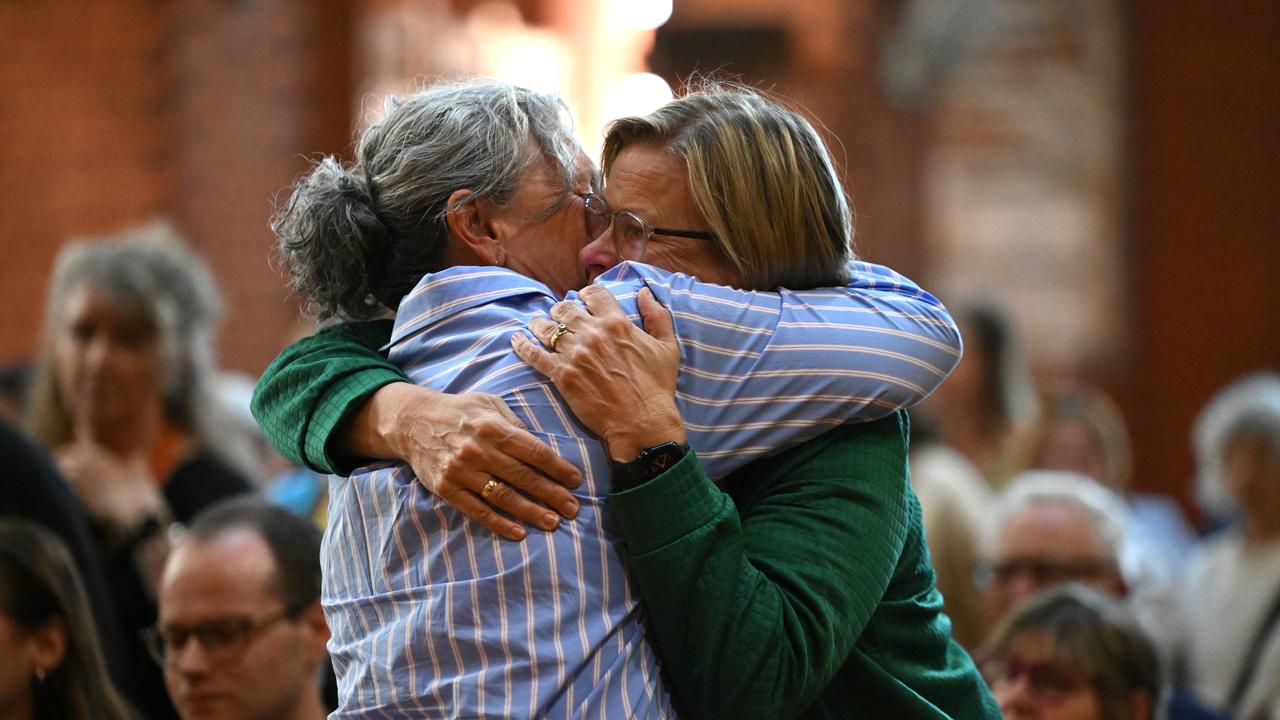 People react during a vigil for independent federal MP Helen Haines