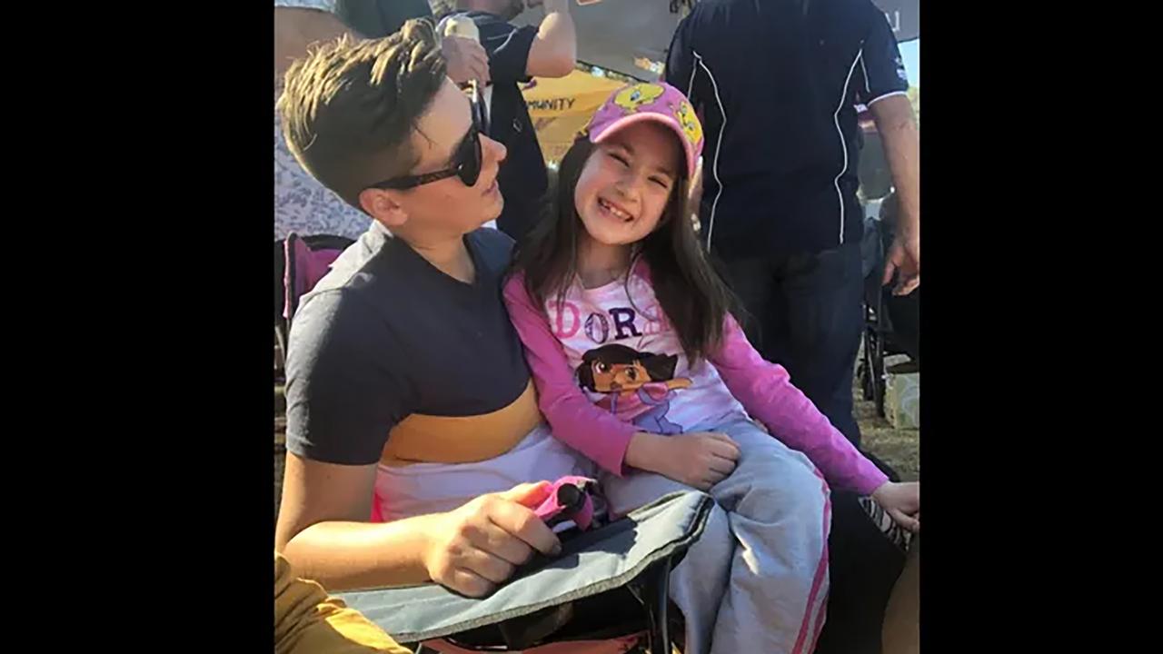 smiling girl on woman's lap