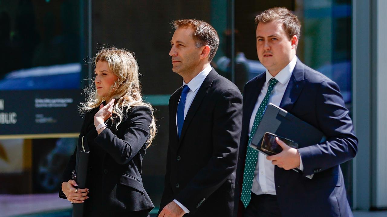 Three people walk into court