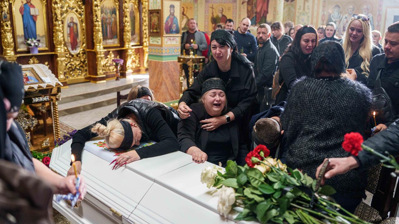 Relatives at the coffin of a 14 year old boy killed in Ukraine