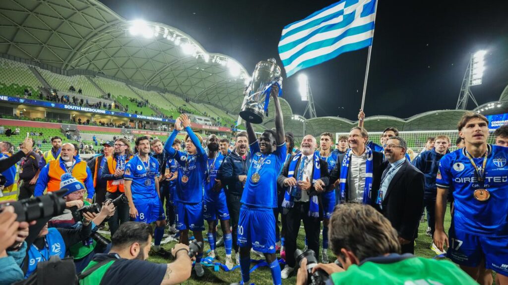 South Melbourne players celebrate with the trophy after winning the Australia Cup final
