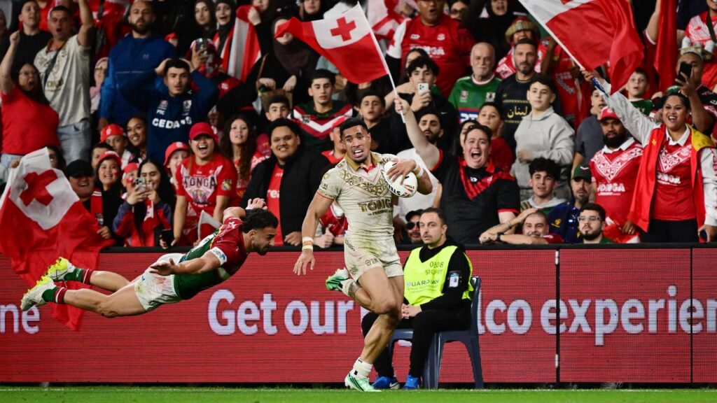 Tolu Koula evades an attempted tackle by Moustafa Dirani of Lebanon to score for Tonga.
