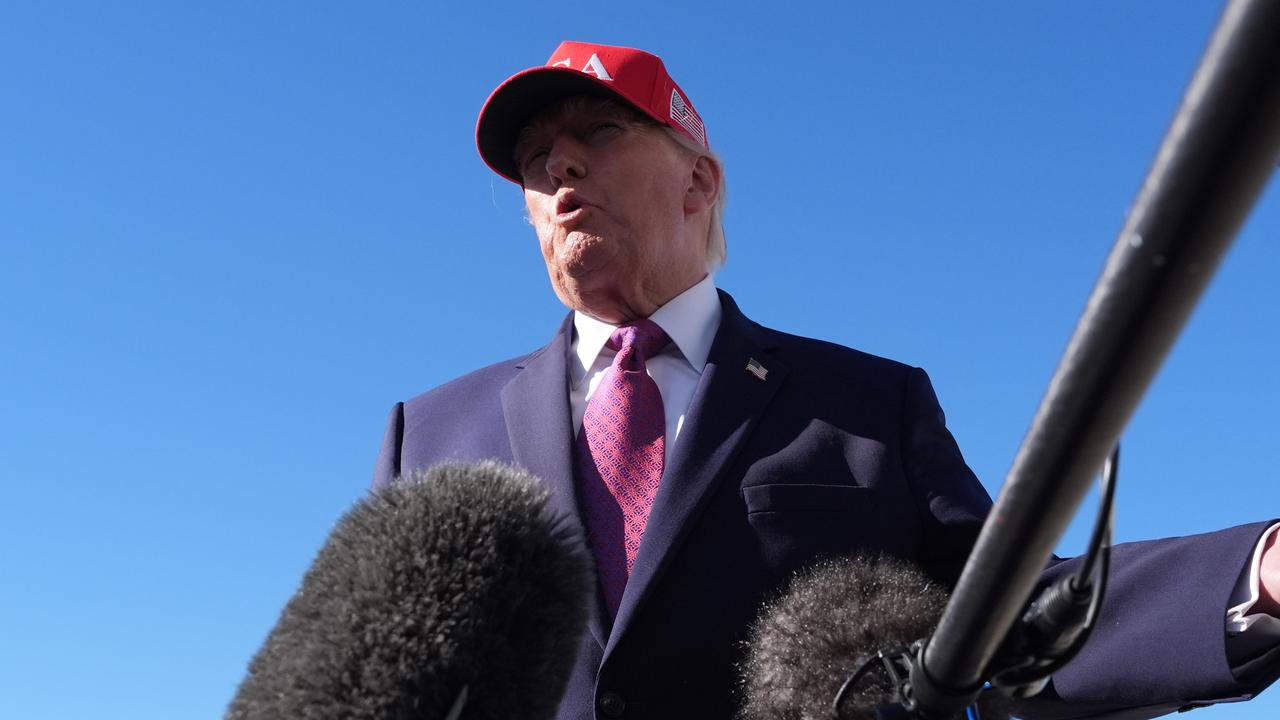 US President Donald Trump talks to reporters