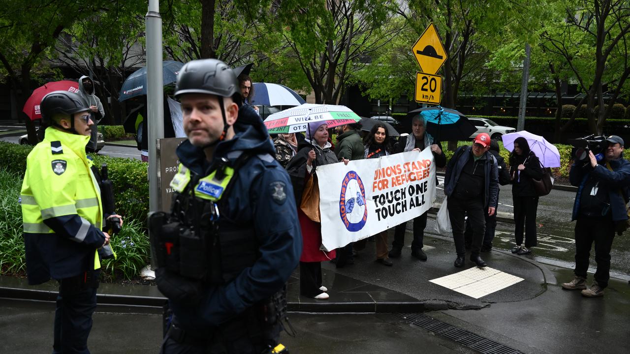 Victoria Police watch on as protesters gathe
