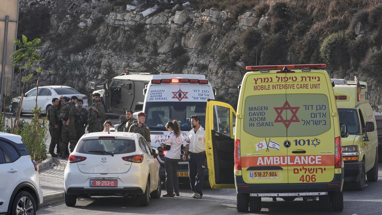 Soldiers and paramedics after a shooting attack near Yehuda Junction