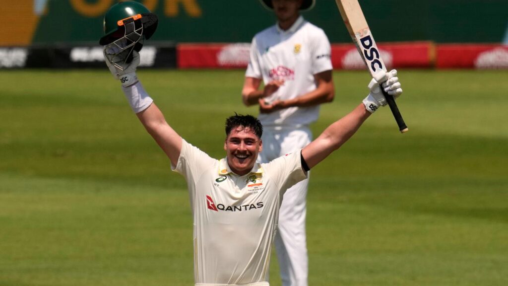Australia’s Matt Renshaw raises his arms in triumph after reaching his second Test century.
