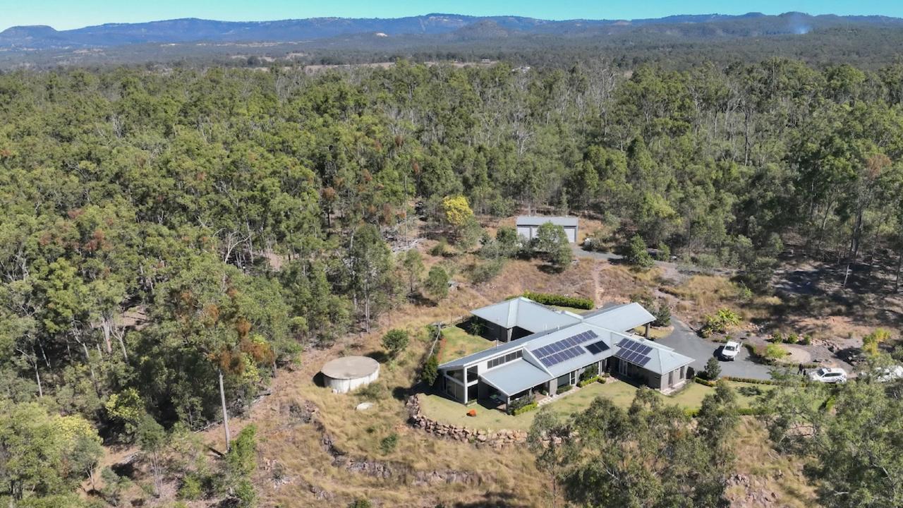 house in a small clearing of forest
