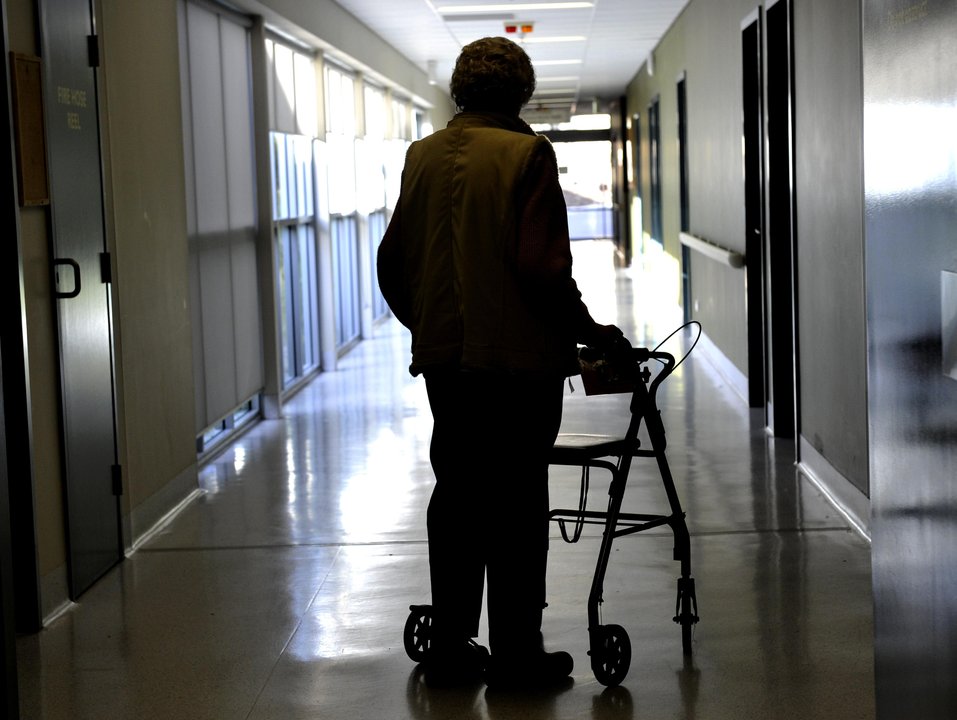 A woman uses a walker