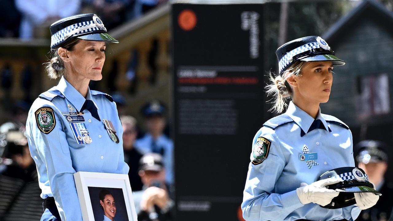NSW Police officers carry the hat and a portrait of Mia Lay